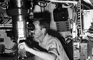 men looking into periscope